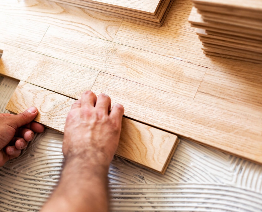 Install parquet Parquet installer laying Strip Parquet on the floor